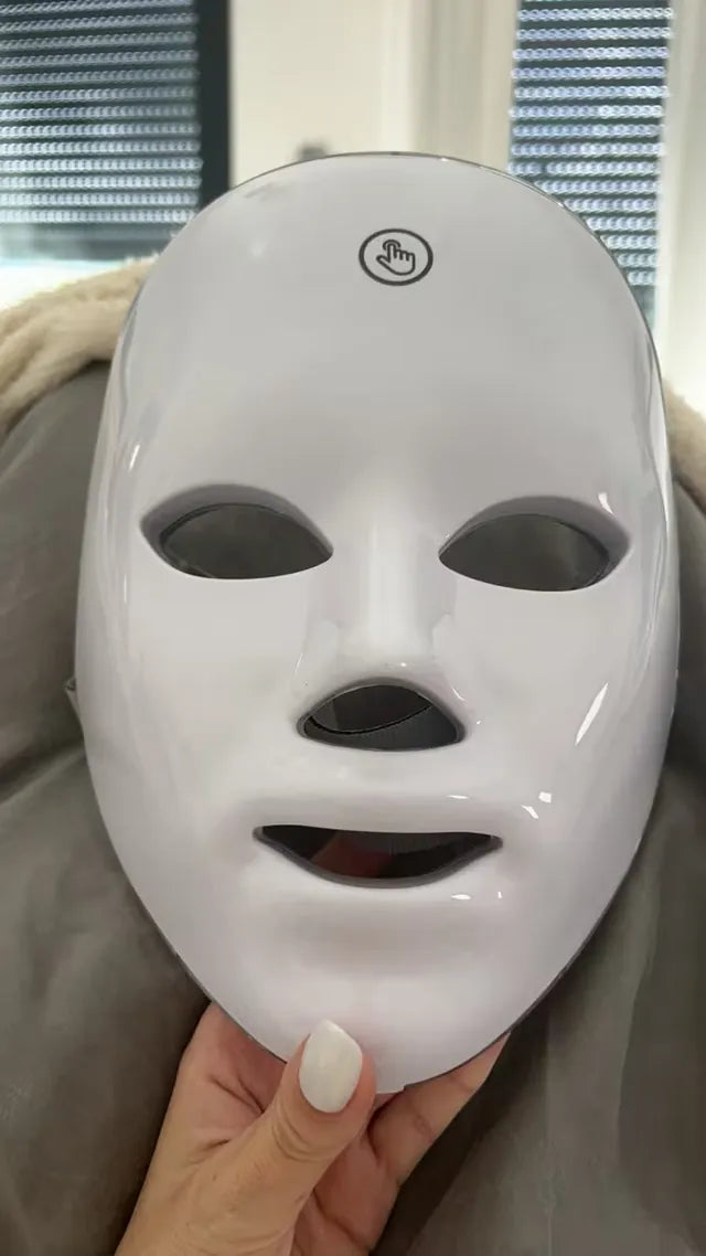 Front of the white LED mask with the one-touch button on the forehead